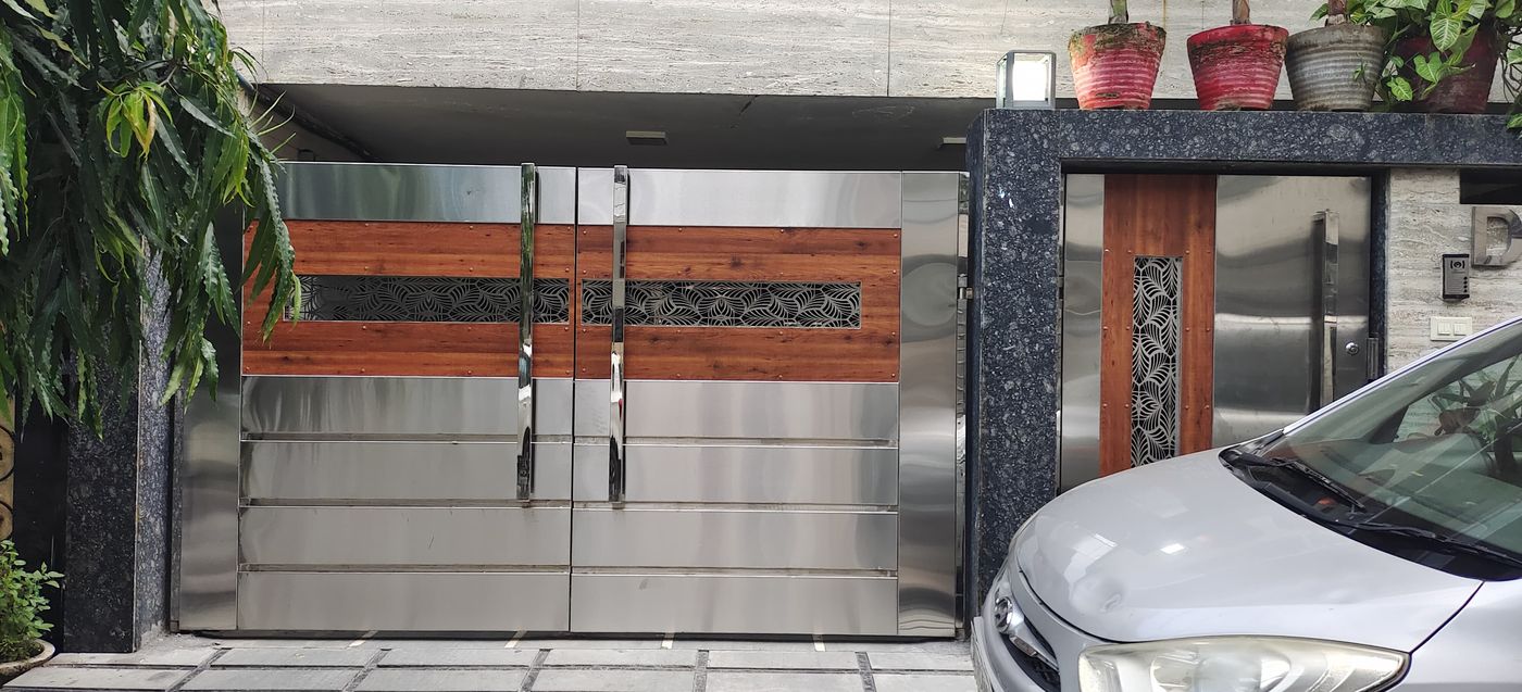 Designer stainless steel and wood-finish main gate fabricated by Giriraj Steel Traders